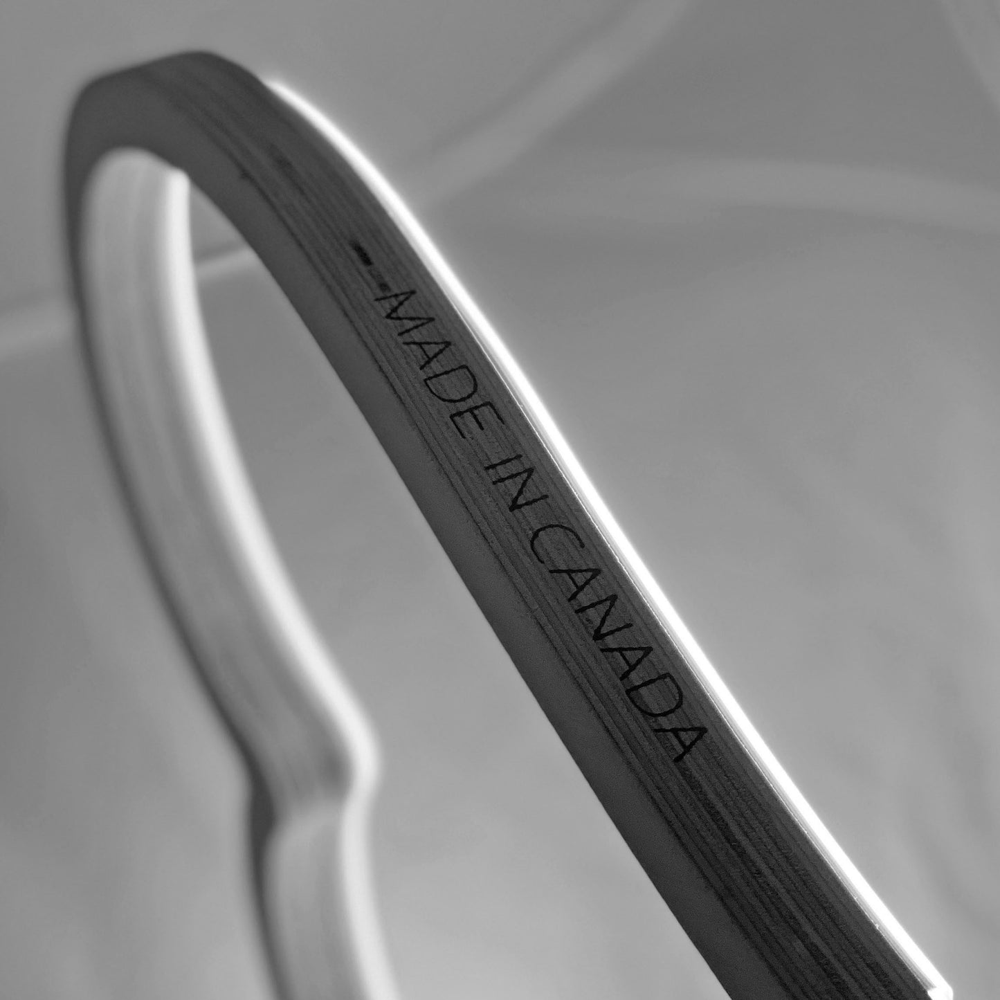 Made in Canada engraving on the wood frame of a warm white neon heart art piece - handcrafted LED neon heart light by Our Glowing Hearts, proudly made in Mississauga, Canada