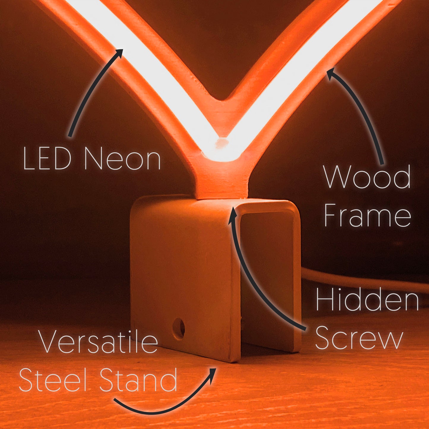 Close-up of mini orange neon heart art construction showing LED neon tubing wood frame hidden screw mount and versatile steel baseplate stand by Our Glowing Hearts