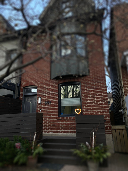 Toronto homes are now displaying glowing neon hearts in their Windows