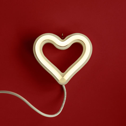 Cool white neon heart ornament glowing on red background - 3.5 inch LED neon ornament by Our Glowing Hearts handmade in Canada