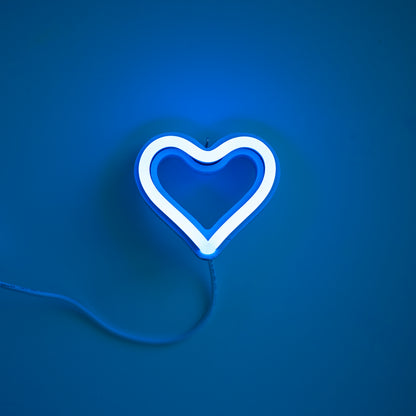 Cyan neon heart ornament art glowing against a blue background - 3 inch LED neon heart light by Our Glowing Hearts handmade in Canada