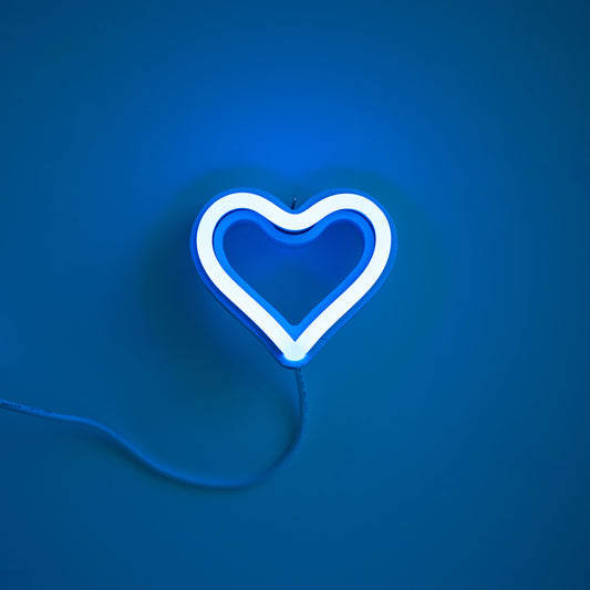 Cyan neon heart ornament art glowing against a blue background - 3 inch LED neon heart light by Our Glowing Hearts handmade in Canada