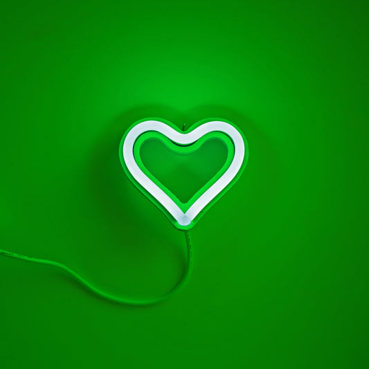 Green neon heart ornament glowing on green background - 3.5 inch LED neon ornament by Our Glowing Hearts handmade in Canada