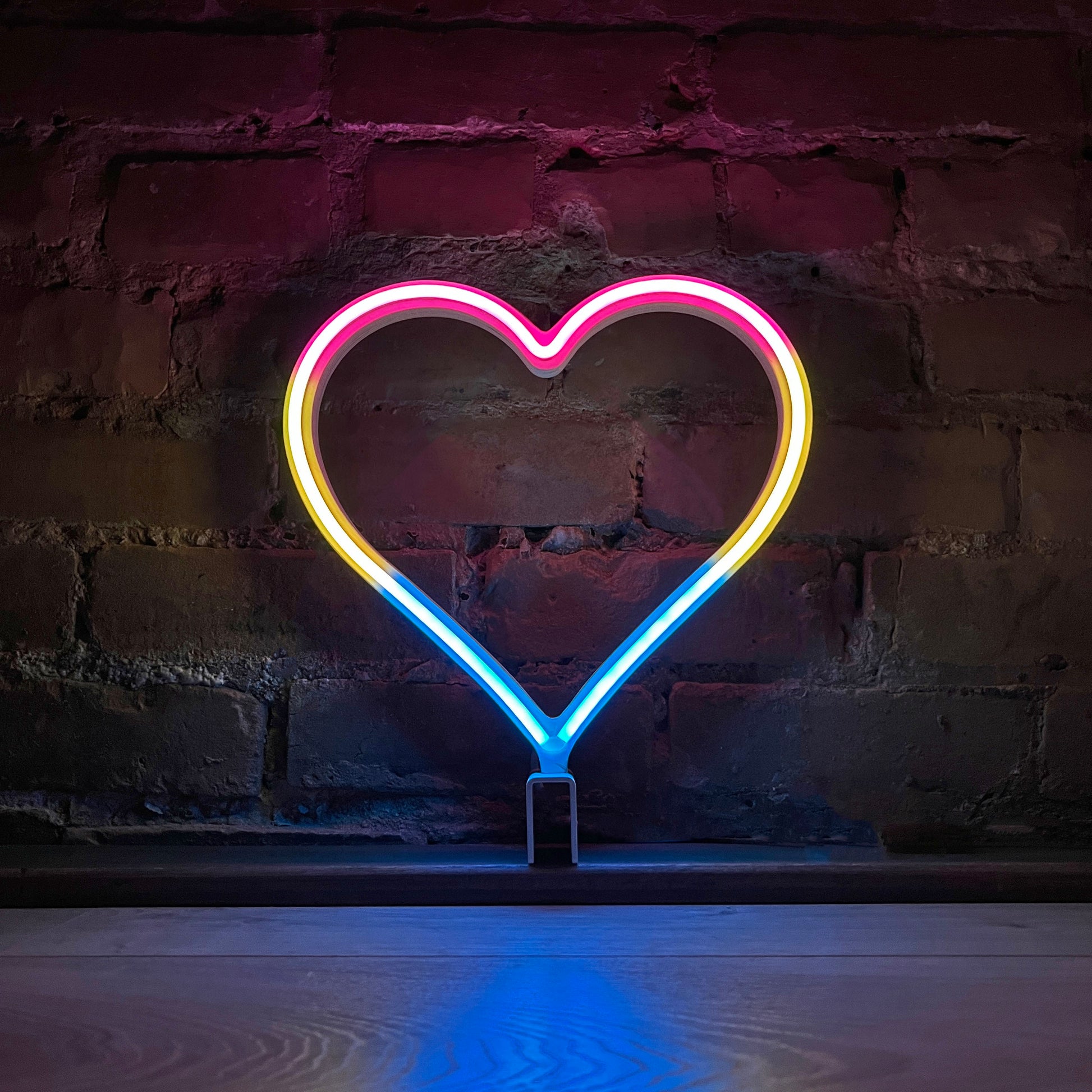 Neon Queer Heart art in pansexual pride flag colors - pink yellow and blue LED neon heart light mode by Our Glowing Hearts