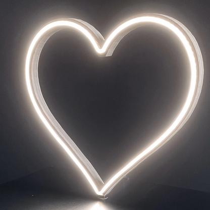 Cool white neon heart art glowing brightly against a dark background - front view of 12 inch LED neon heart light showing warm white glow by Our Glowing Hearts