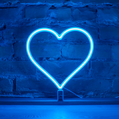 Cyan neon heart art glowing against a brick wall - 12 inch LED neon heart light by Our Glowing Hearts, handmade in Canada
