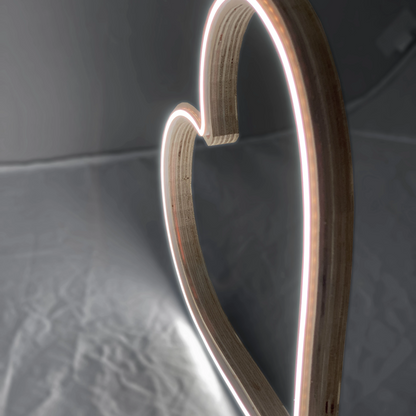 Close-up of neon heart art showing laminated wood frame and LED neon tubing detail - handcrafted heart-shaped wall art by Our Glowing Hearts, handmade in Canada
