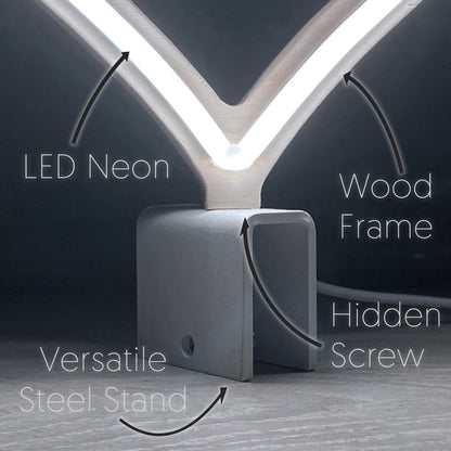 Close-up of mini cool white neon heart art construction showing LED neon tubing wood frame hidden screw mount and versatile steel baseplate stand by Our Glowing Hearts