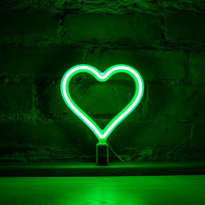 Mini green neon heart art glowing against a brick wall - 7 inch LED neon heart light by Our Glowing Hearts handmade in Canada