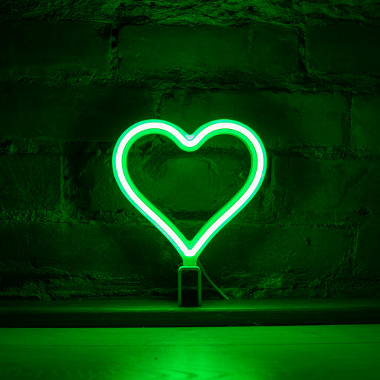 Mini green neon heart art glowing against a brick wall - 7 inch LED neon heart light by Our Glowing Hearts handmade in Canada