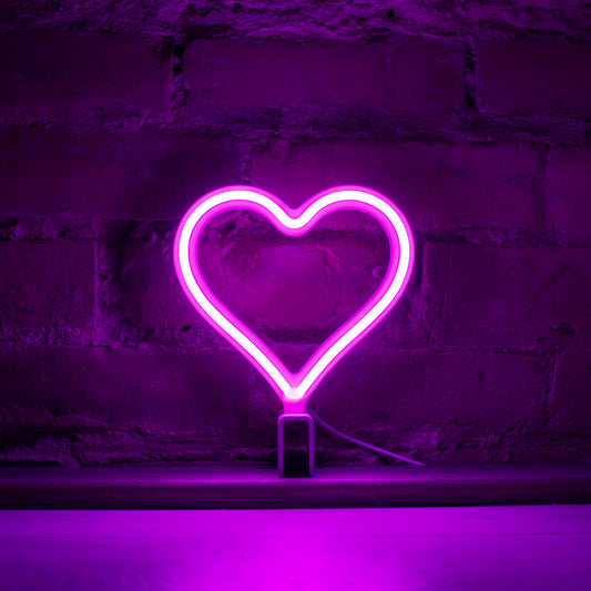 Mini magenta neon heart art glowing against a brick wall - 7 inch LED neon heart light by Our Glowing Hearts handmade in Canada