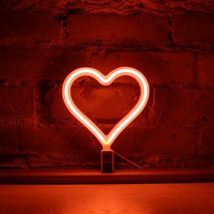 Mini orange neon heart art glowing against a brick wall - 7 inch LED neon heart light by Our Glowing Hearts handmade in Canada