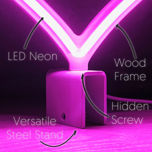 Close-up of mini pink neon heart art construction showing LED neon tubing wood frame hidden screw mount and versatile steel baseplate stand by Our Glowing Hearts