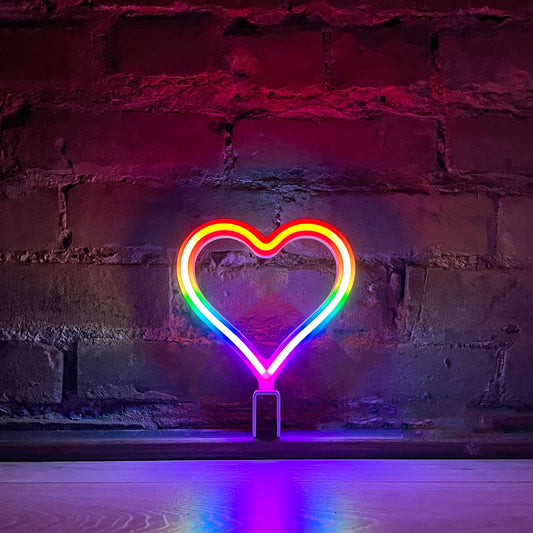 MINI Signature Rainbow neon heart art glowing against a brick wall - 7 inch LED neon heart light by Our Glowing Hearts handmade in Canada