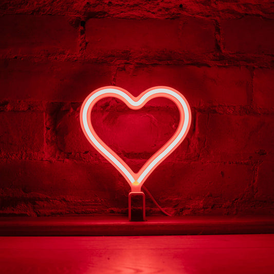 Mini red neon heart art glowing against a brick wall - 7 inch LED neon heart light by Our Glowing Hearts handmade in Canada