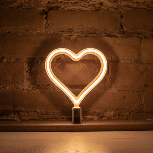 Mini warm white neon heart art glowing against a brick wall - 7 inch LED neon heart light by Our Glowing Hearts handmade in Canada