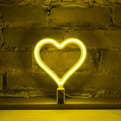 Mini yellow neon heart art glowing against a brick wall - 7 inch LED neon heart light by Our Glowing Hearts handmade in Canada