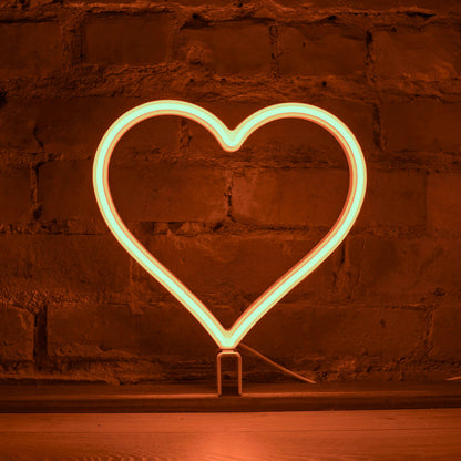 Orange neon heart art glowing against a brick wall - 12 inch LED neon heart light by Our Glowing Hearts, handmade in Canada