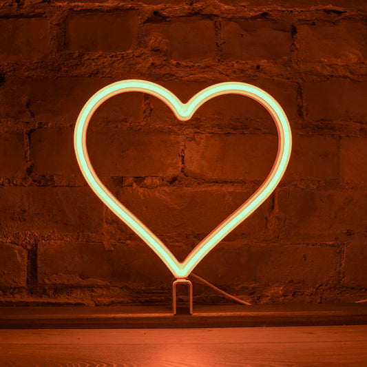 Orange neon heart art glowing against a brick wall - 12 inch LED neon heart light by Our Glowing Hearts, handmade in Canada