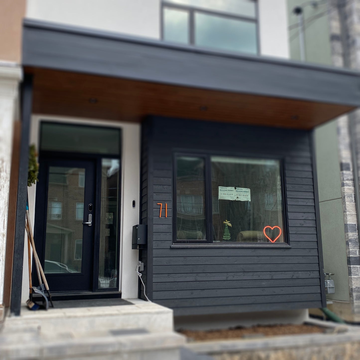Orange neon heart art displayed in a modern home window during the day - LED heart-shaped light visible from outside, perfect for window decor by Our Glowing Hearts