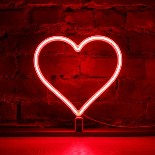 Red neon heart art glowing against a brick wall - 12 inch LED neon heart light for Light Up Live by Our Glowing Hearts, handmade in Canada